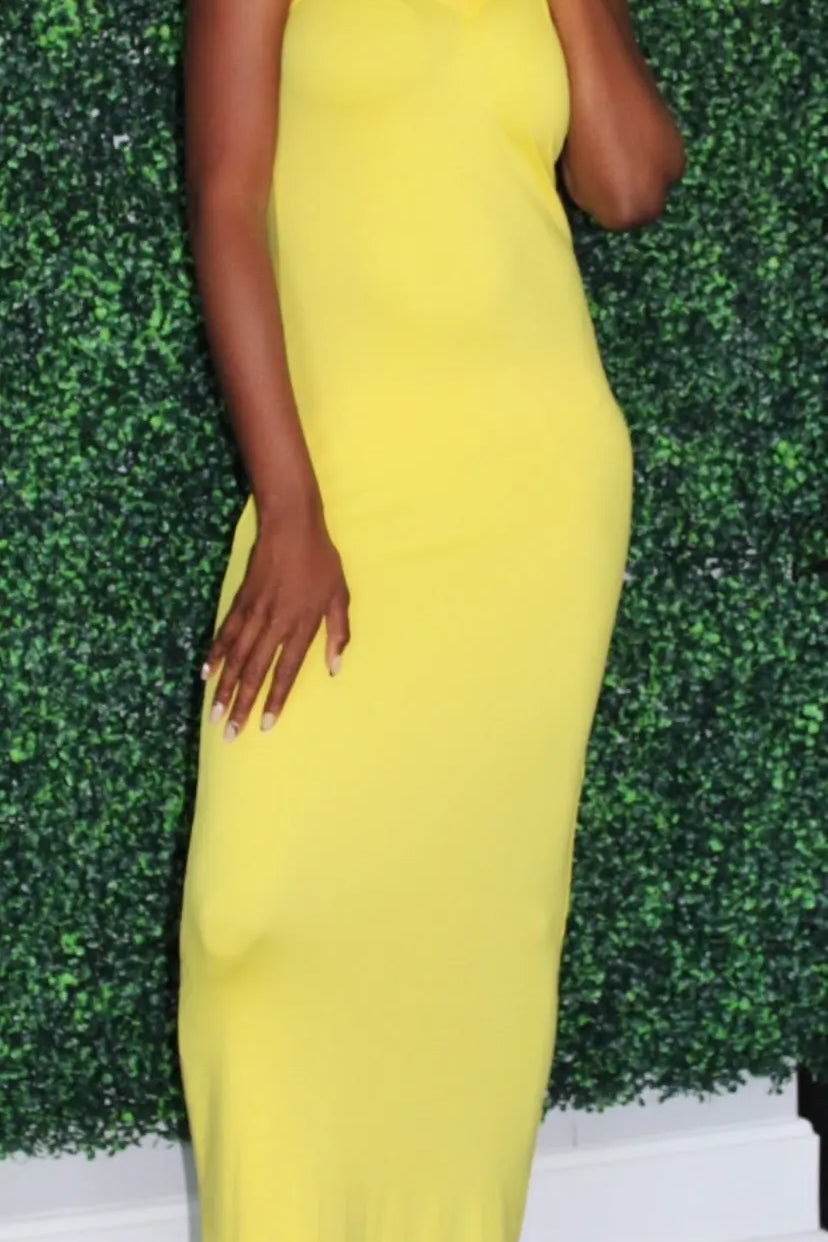 Model is wearing a yellow maxi dress