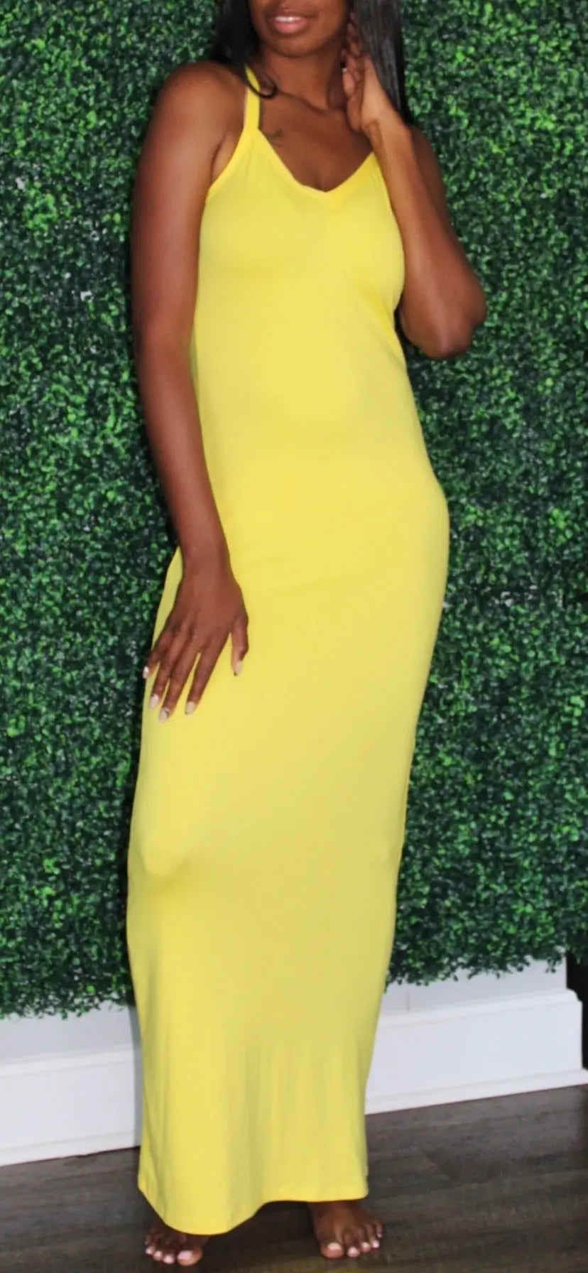 Model is wearing a yellow maxi dress